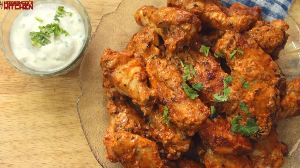 Butter chicken wings with cilantro and a side of chatpata dip