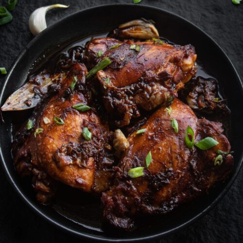 a plate of chicken adobo