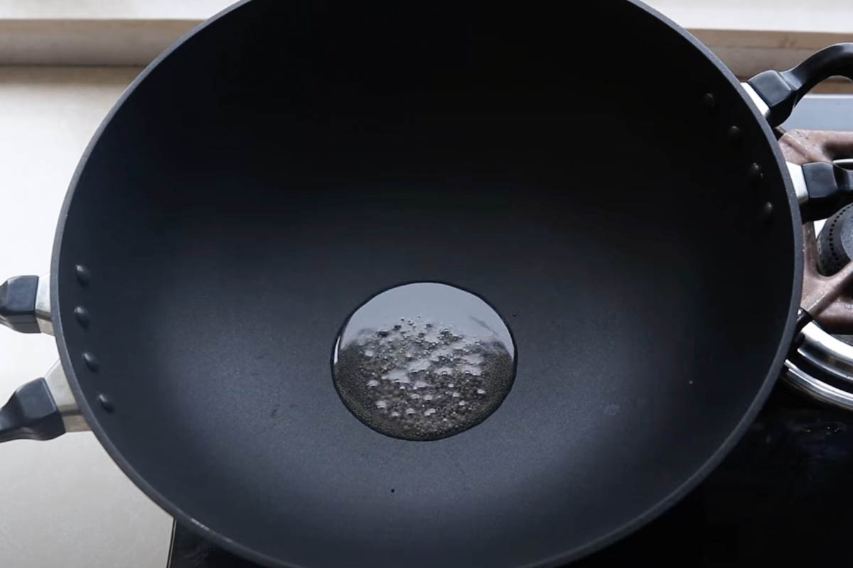 Heating mustard seeds in oil in a pan