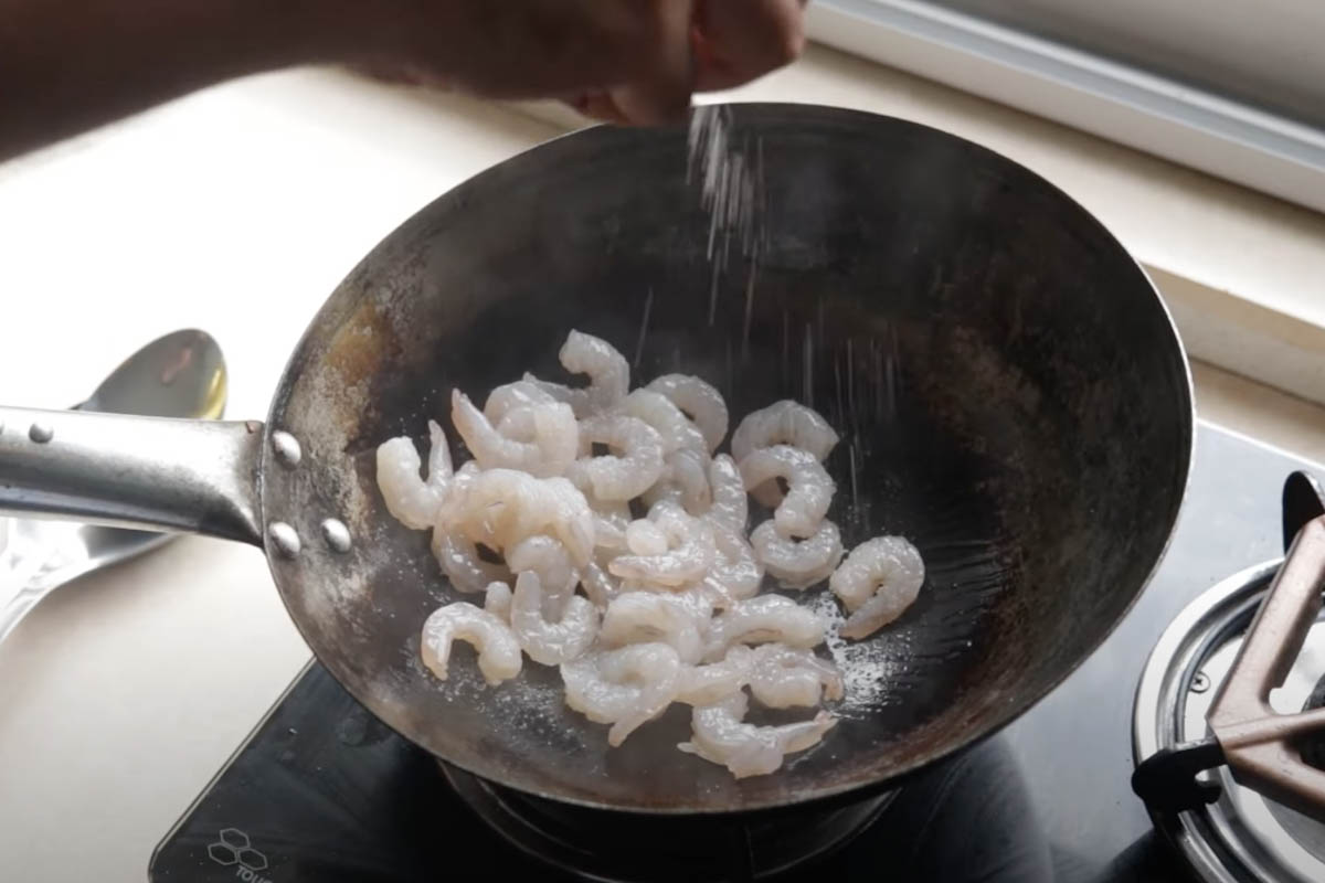 Shrimp stir frying in a wok