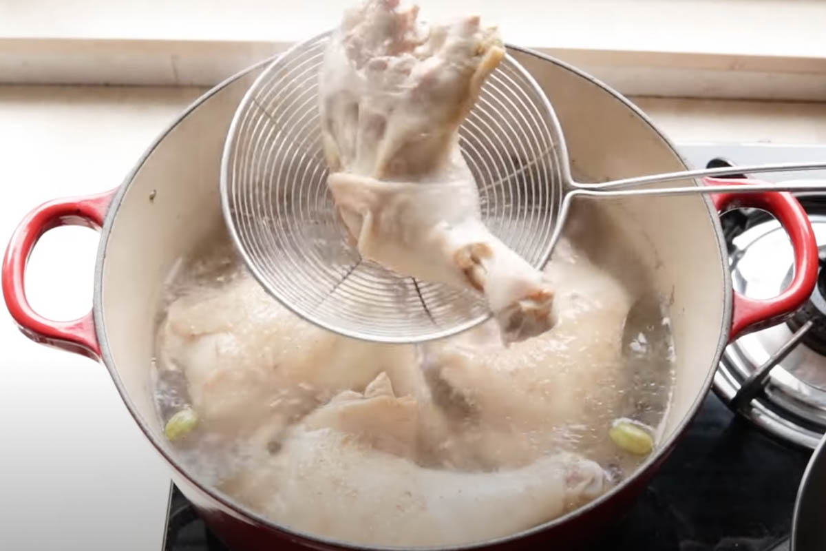 Removing chicken from the broth