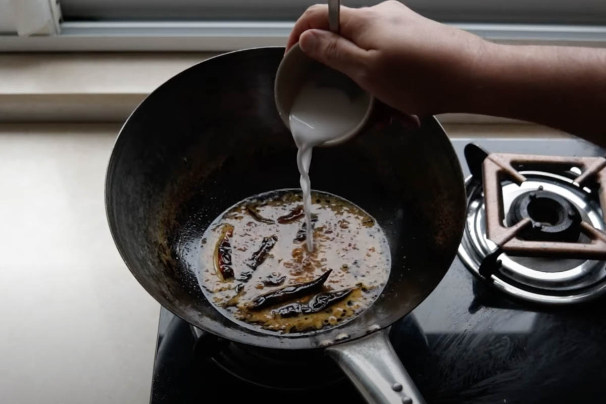 Making the orange chicken sauce in a wok