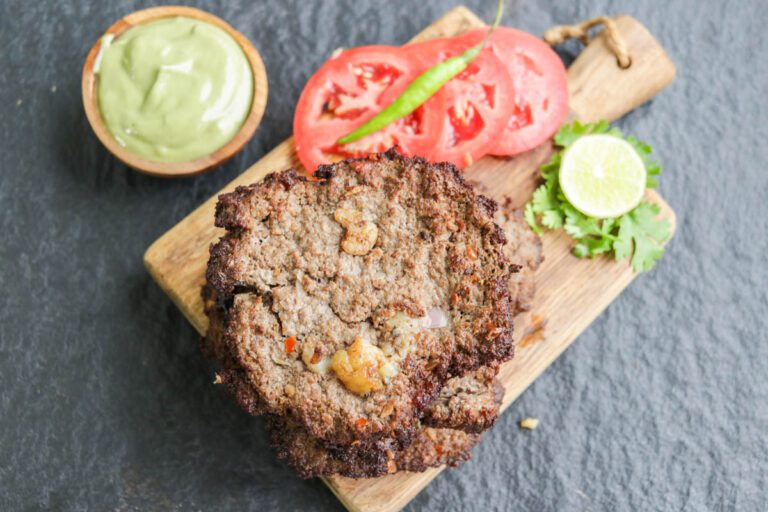 Pakistani Chapli Kabab on a wooden board