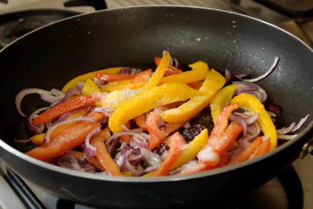 Adding Erythritol to the red onion and peppers 