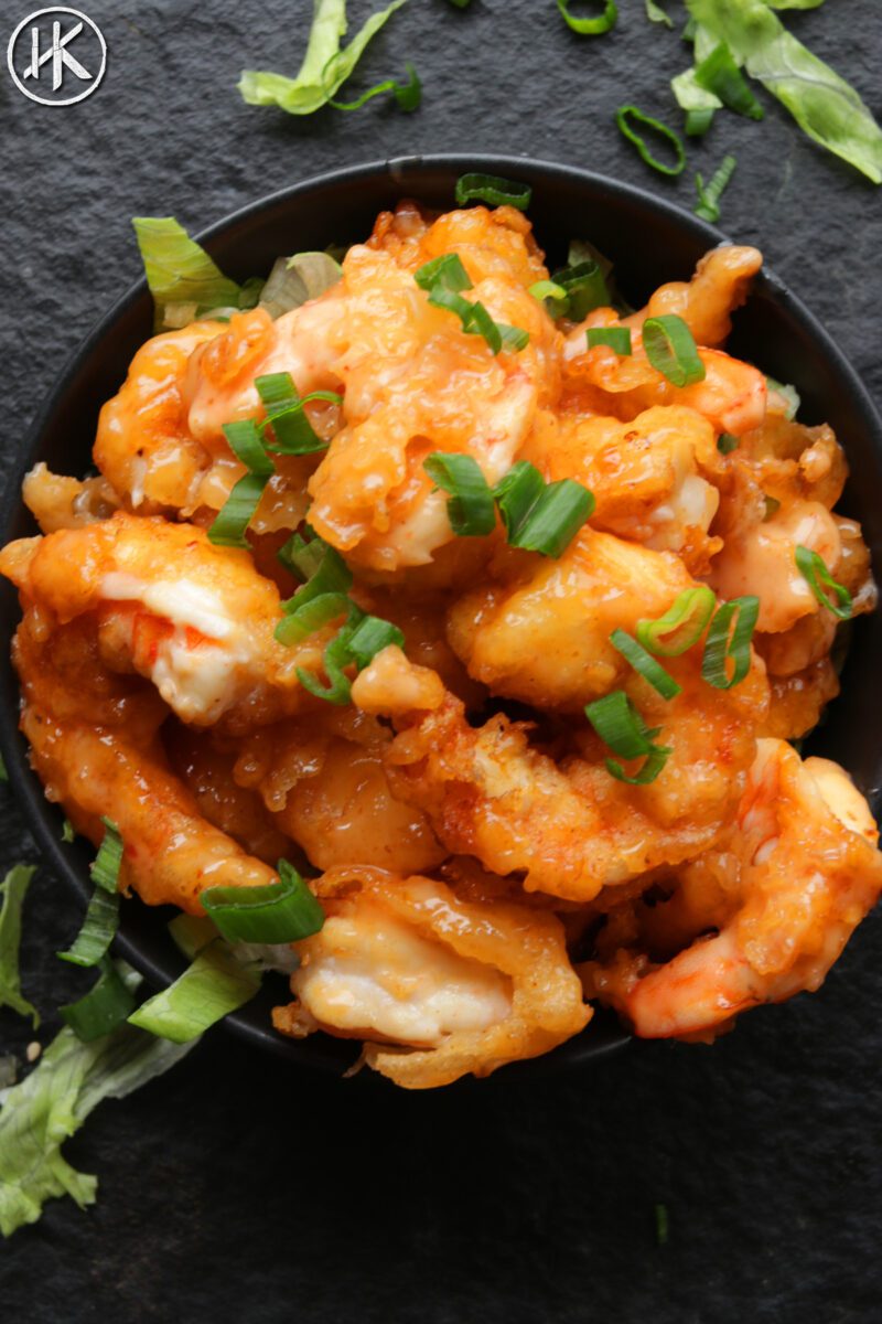 Bang bang shrimp in a bowl with scallions