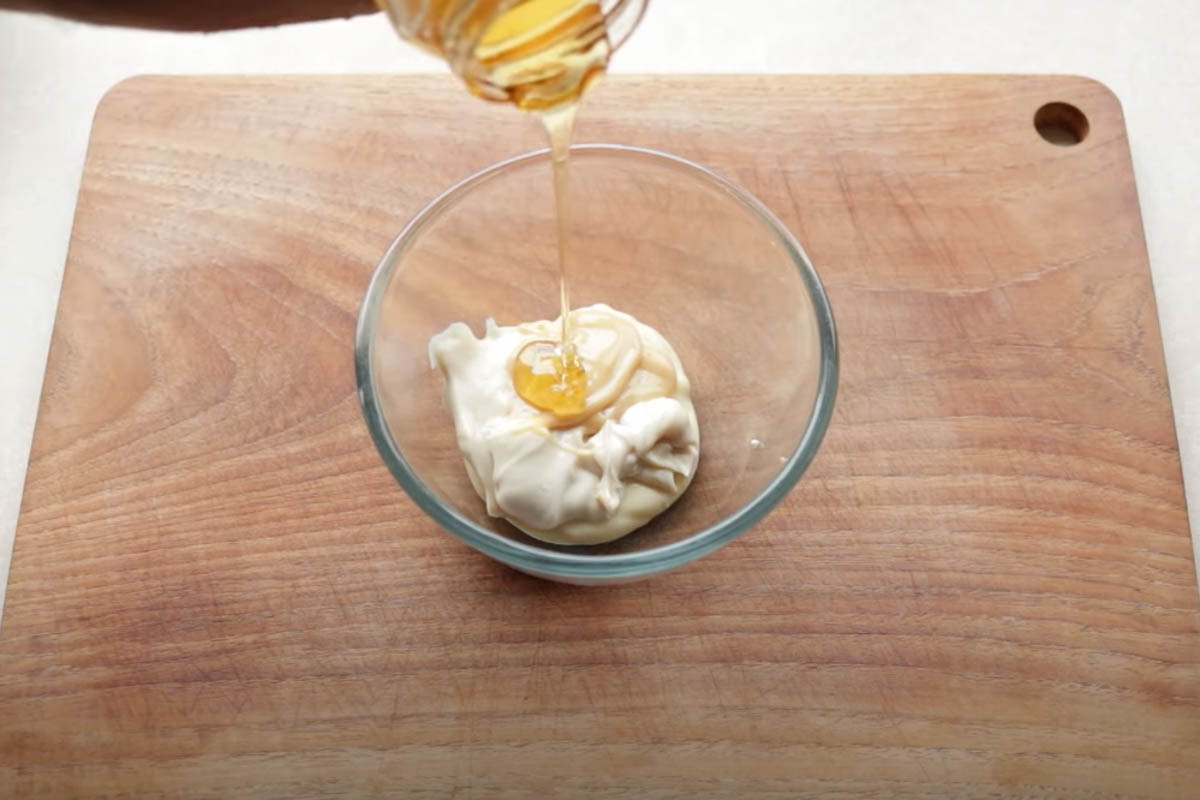 Mayo, condensed milk, honey, and lemon juice in a mixing bowl