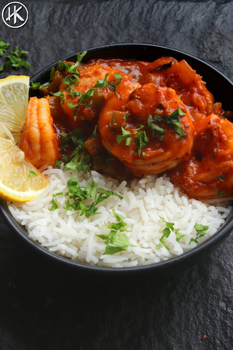 Shrimp creole in a bowl with rice and fresh lemon slices