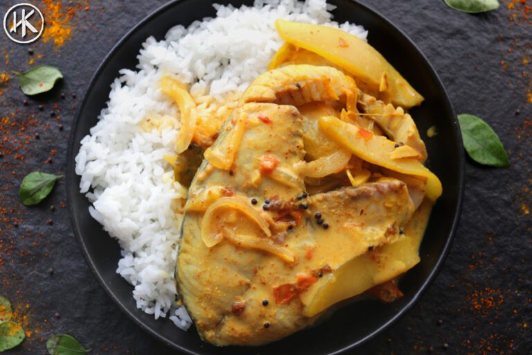 Mango fish curry on a plate with rice.
