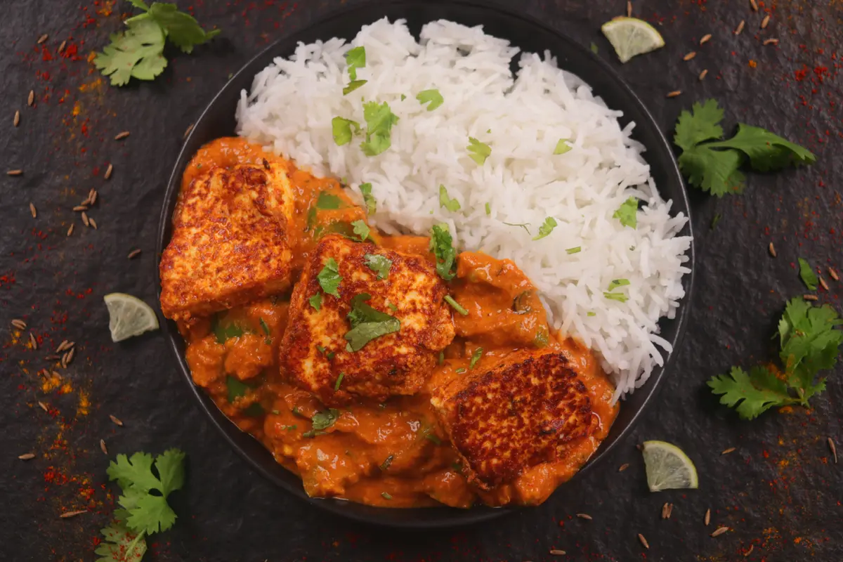 Paneer tikka masala on a kitchen table.